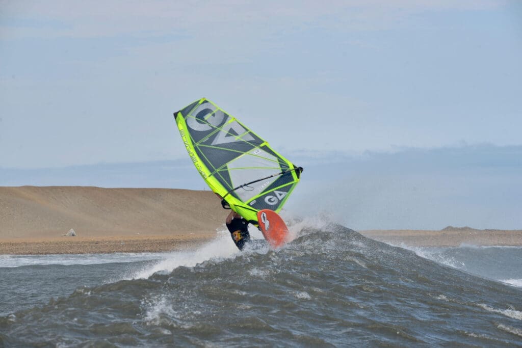 Adrian Levy windsurfing in Pacasmayo at the world cup. Adrian is a member of the NSW Wave Sailingh Association. IN this photo you can see him performing a wave sailing move with his Gastra Sail. 